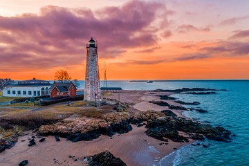 lightouse at sunrise with oyster boat in background - obrazy, fototapety, plakaty