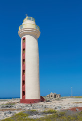 Fototapeta na wymiar Lighthouse with ruin on coast of Bonaire