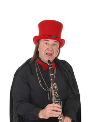 A clarinet player with a red hat and black outfit