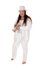 A trumpet player standing in a white outfit and hat