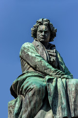 Sculpture of Ludwig van Beethoven in Vienna. Below is an ancient goddess with laurel wreath in hand