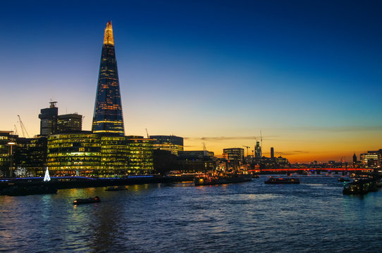 The Shard skyscraper on South Bank of river Thames at sunset, London, England