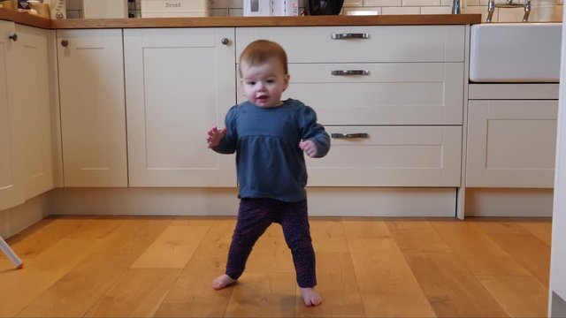 4K: Baby girl / Toddler taking first few steps Walking in the home - Walks to Camera