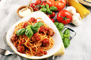 Spaghetti pasta with meatballs and tomato sauce with basil and parmesan