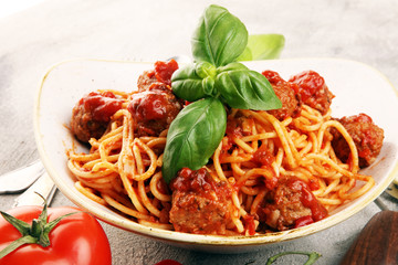 Spaghetti pasta with meatballs and tomato sauce with basil and parmesan