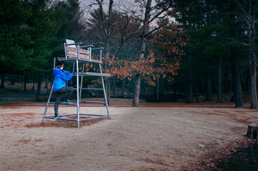 Woman Climbs to Lifeguard Chair in Off-Season