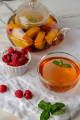 Fruit hot tea with the addition of oranges, lemons, raspberries and mint