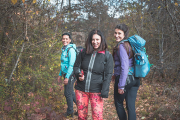 Three girls, hikers, happy and smiling posing for photo. Hiking, backpacking