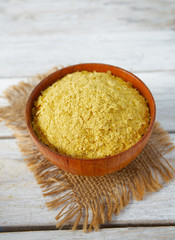 nutritional yeast flakes on wooden surface