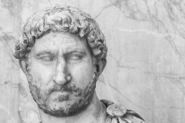 Black and white close up photo of male head of classical roman statues