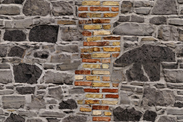 seamless texture of the old stone wall for the designer, rough gray background with an insert of red bricks