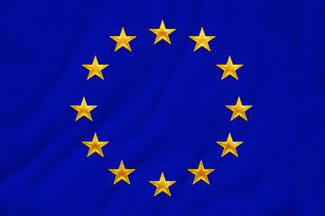 European Union flag, symbol of united Europe on soft silk with soft folds, close-up