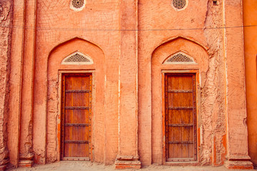 Old red doors in village house in India