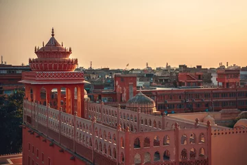 Fotobehang An aerial view on the street in front of the Hawa Mahal also known as the Palace of the Winds in the pink city of Jaipur in Rajasthan © popovatetiana