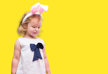 Lovely blonde toddler wearing easter bunny ears