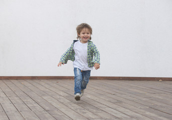 Happy boy runs around the stage. Blurred image - 316641294