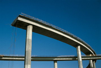 This shows a freeway under construction. It is the end of the road. The upper level of the road curves around and then just completely ends in mid-air.