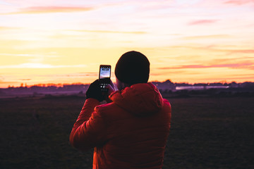 Photographer Taking A Photo Of A Sunset.