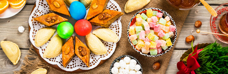 Novruz Ramadan in Azerbaijan. Colored Eggs, Wheat Springs for Easter and Traditional Sweets. Selective focus.