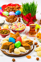 Novruz Ramadan in Azerbaijan. Colored Eggs, Wheat Springs for Easter and Traditional Sweets. Selective focus.