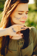 Woman in a summer field. Cute lady drawing. Girl with colorful paints