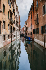 Fototapeta na wymiar Typical Venice narrow canal with boats. Italy