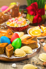 Novruz Ramadan in Azerbaijan. Colored Eggs, Wheat Springs for Easter and Traditional Sweets. Selective focus.