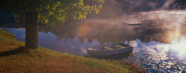 This is a row boat sitting at the edge of a pond in autumn. The pond is near Route 10. © spiritofamerica