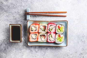 japanese sushi food. Rolls with tuna, salmon, shrimp, crab and vegetables. Top view of assorted sushi. Rainbow sushi roll on stone background. Flat lay