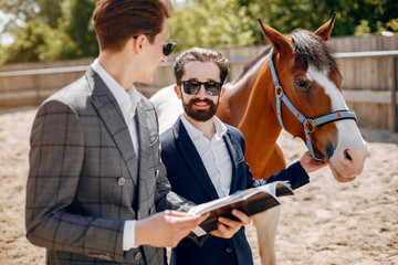 Fototapeta premium Horse theme. Businessmen with a horse. Men in a suit