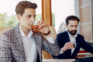 Two handsome men working. Friends talking. Man in a suit