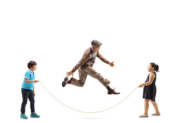 Children and an elderly man playing skipping rope