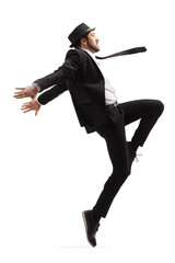 Male dancer in a black suit and hat dancing