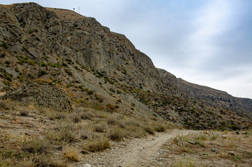 Mountain landscape. Mountain trail off the coast. Travel and adventure.