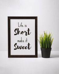 Motivational and Inspirational Quotes. Life is Short Make it Sweet. Still Life of Word Frame on Work Desk.