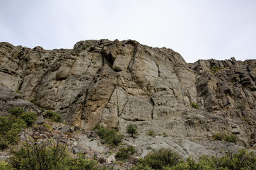 Mountain landscape. Sheer cliff and sky. Travel and adventure.