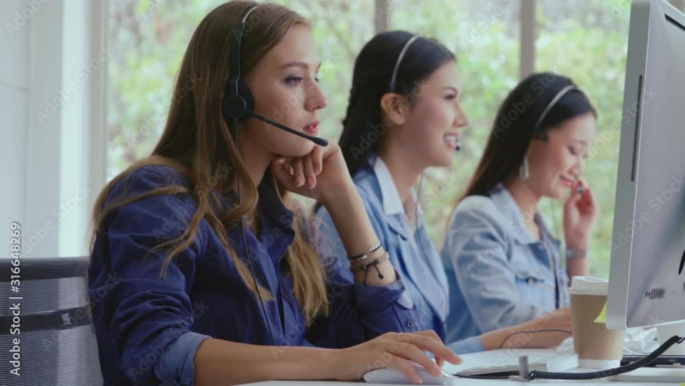 Aufkleber customer support agent or call center with headset works on desktop computer while supporting the cu