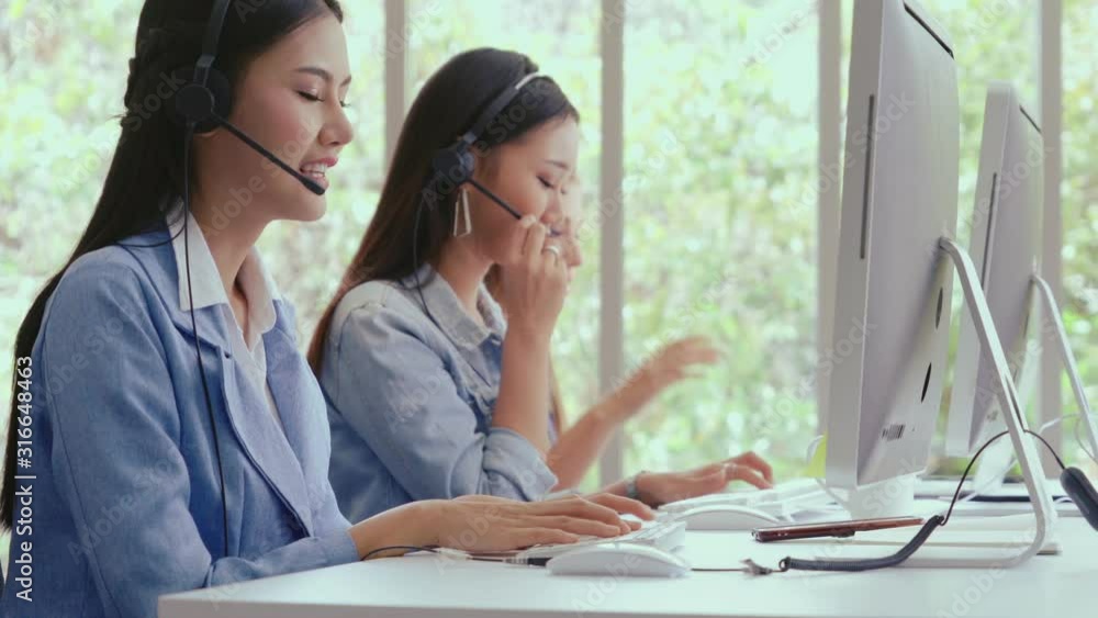 Aufkleber customer support agent or call center with headset works on desktop computer while supporting the cu