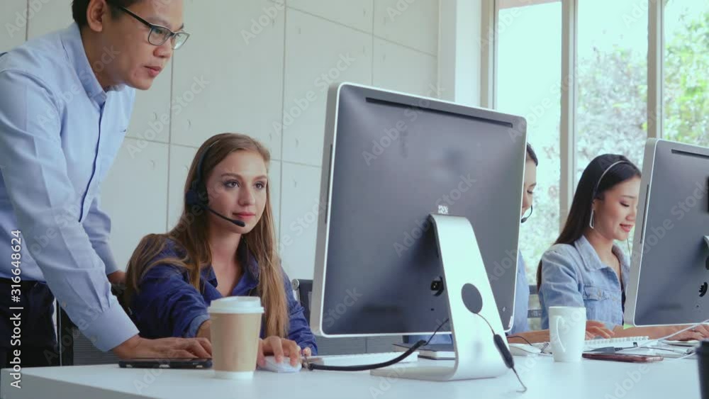 Aufkleber customer support agent or call center with headset works on desktop computer while supporting the cu