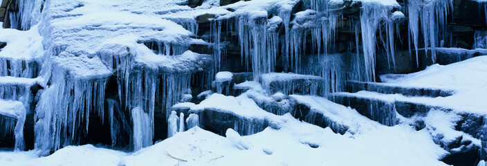 These are Icicles in the Sierra Mountains in winter. The icicles overhang the ledges they are formed upon.