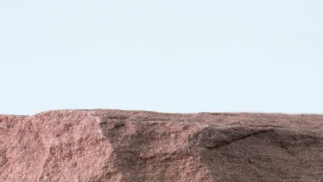 Close up Move the camera angle from left to right,  Rock cliff on White background, for product display, Blank for mockup design.