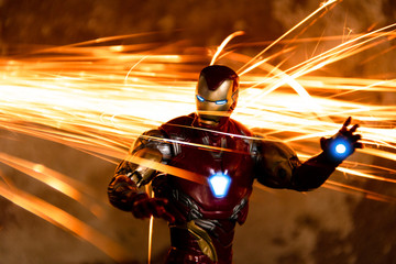 TOKYO, JAPAN - JANUARY 17, 2020 :  Fighting pose of Iron Man action figures in fire sparks. Iron Man is a fictional superhero appearing in American comic books published by Marvel Comics.