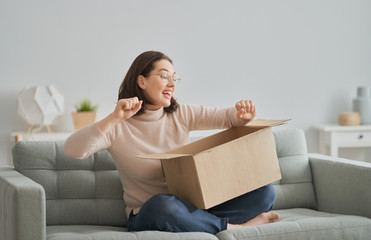 woman is holding cardboard box