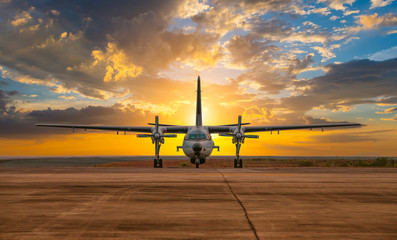 A Airplane passenger or cargo plane on runway is waiting take off flying away go to high altitude during sunset time sky background. 