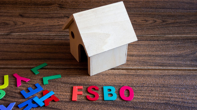 Property concept. FSBO text on wooden background. For sale by owner