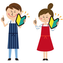 ポップなエプロンを着た男女が初心者マークを持つ