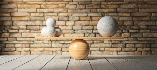 wooden scale balancing one big ball and four small ones on wooden floor
