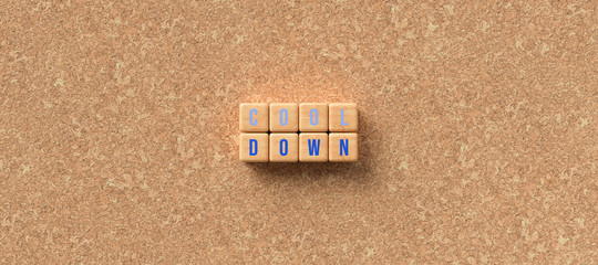 cubes with words COOL DOWN on a cork board