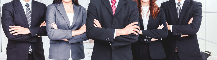 Successful professional group of business people man and woman team standing folded hand at office