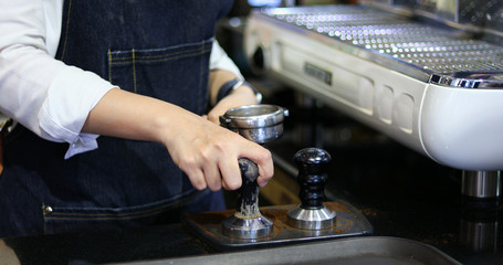 Asian women Barista smiling and using coffee machine in coffee shop counter - Working woman small business owner food and drink cafe concept